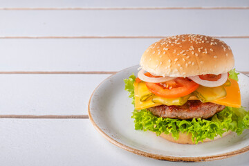 Burger with beef cutlet, cheese, onion, tomato and lettuce. Space for text