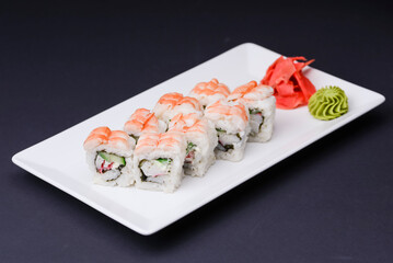 Shrimp sushi close up, Japanese cuisine. Asian cuisine concept. Served on a white plate over black background