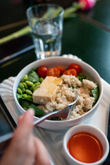 Healthy breakfast bowl with porridge and fresh vegetable salad