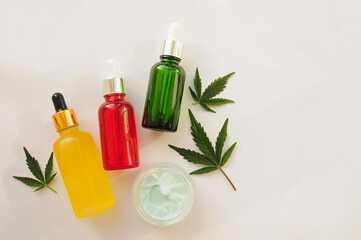 Fototapeta na wymiar Marijuana leaves, cbd oil, cosmetic cream. Cannabis extract in cosmetology. Flat lay, powder background. Home relaxation, spa recreation, pastime therapy.
