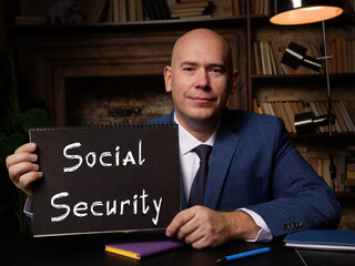 Man wearing blue business suit and showing black notepad with written text Social Security ....
