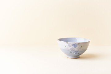Traditional ceramic bowl on bright  background. Close up. Copy space. 