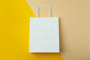 Blank paper bag on two tone background, space for text
