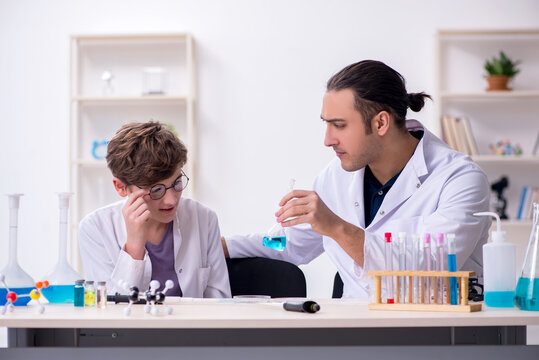 Young father and son chemists in the lab - Powered by Adobe