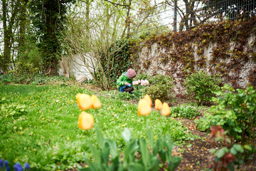 Kind sucht Ostereier im Garten zu Ostern die versteckt sind