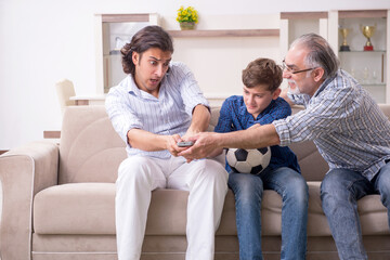 Boy and his father and his grandfother indoor