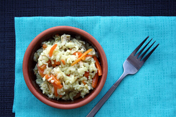 Flavorful pilaf of rice, carrots and chicken.
