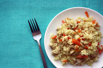Flavorful pilaf of rice, carrots and chicken.