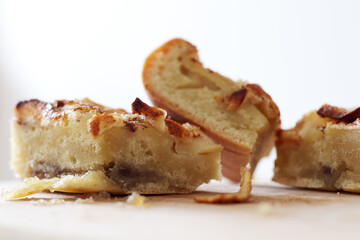 pieces of homemade apple pie with cinnamon on wooden board
