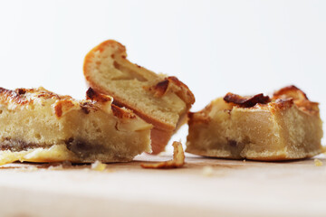 pieces of homemade apple pie with cinnamon on wooden board