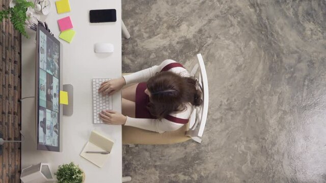 Asian Woman Talking To Multi Ethnic Group Of Business People Working From Home And Office, Talking To Colleagues In Webcam Group Video Call Conference Technology On Screen Online In Quarantine. Team