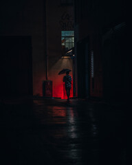 Fototapeta na wymiar Man alone in a dark alleyway