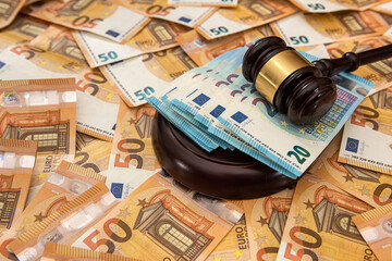 Judge hammer on 50 Euro banknotes background