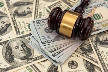 dollar money and judges gavel on table