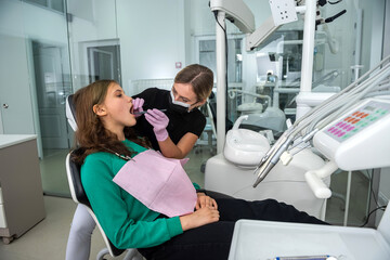  female dentist preparing for dental exam young woman patient