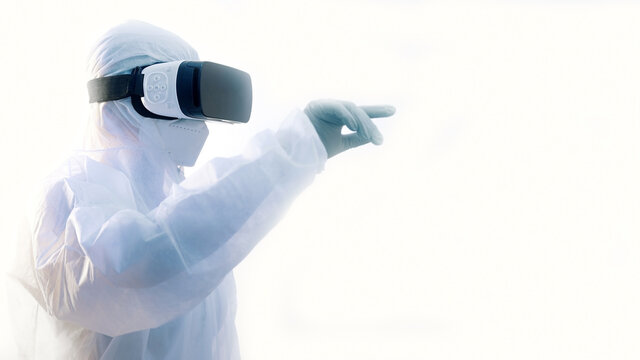 Futuristic laboratory. Doctor in protective suit with VR glasses performing research in virtual reality simulation. High quality photo