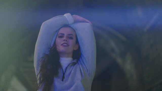 Portrait of smiling woman with arms raised, London, UK