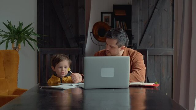 father trying to teach child homeschooling lessons at home