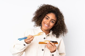 Young African American woman holding sushi isolated on white background