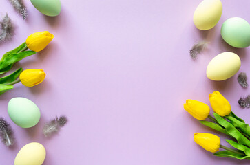 Naklejka na ściany i meble Easter flat lay. Painted eggs with tulips and feathers on lilac background, space for text