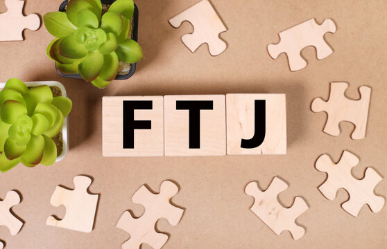 FTJ. text on wood cubes. text in black letters on wood blocks