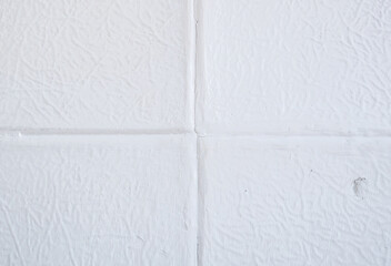 White textured background with rough ripped scratches. Tiles on the wall.