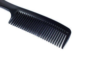 Black comb on white background. Close up.