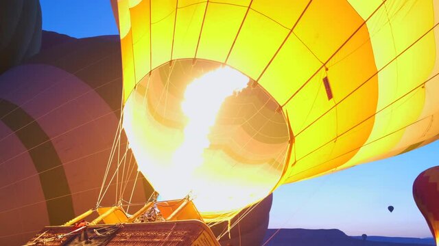 Powerful Jet of Flame Heats Air in Balloon. Warm Air Raises Ball to Sky. Tourist Entertainment. Hot Air Balloon Flight. Bright Flame. Turkey. Cappadocia. Air Travel Festival. Vacation. Liberty. Sky