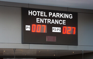 hotel parking garage entrance sign with digital or electronic display providing information about number of bays open concept technology
