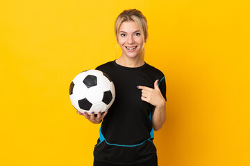 Young Russian football player woman isolated on yellow background with surprise facial expression