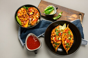 Stuffed sweet potato with spiced chickpea, dressing and herbs.