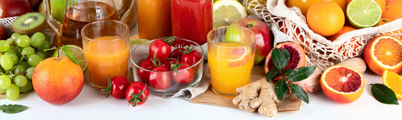 Healthy home made juices and fruits on light wooden background