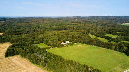 Fototapeta na wymiar green field in the country side with farm