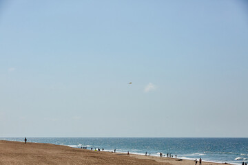 blue and clear water on the beach with people