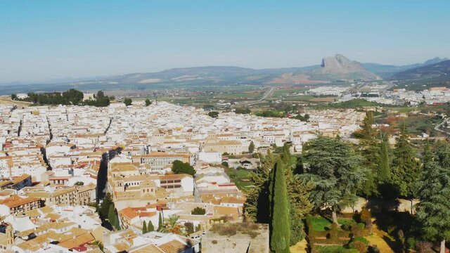 Aereal view of Antequera in foreground and antropomorphic rock looks like indian head in background. Andalusia, Spain