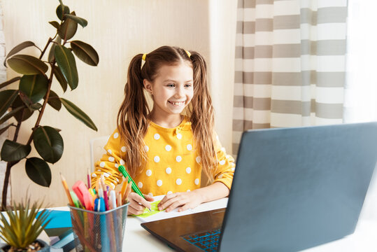 Children learn english online at home. Homeschooling and distance education for kids. Girl student study online with video call teacher