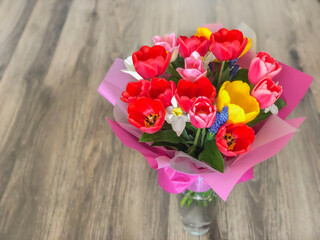 bouquet of colorful tulips on table with copy space
