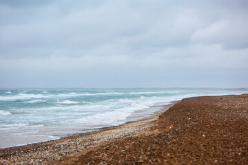 landscape of the blue beach with rocks in the sand