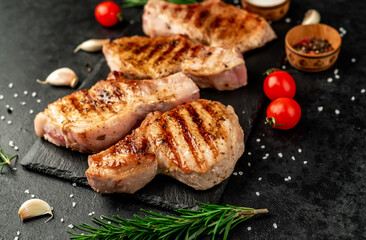 grilled pork steaks on stone background