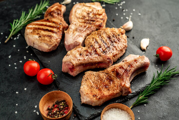 grilled pork steaks on stone background