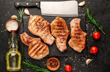 grilled pork steaks on stone background