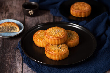 Chinese Mid-Autumn Festival moon cake on wooden background