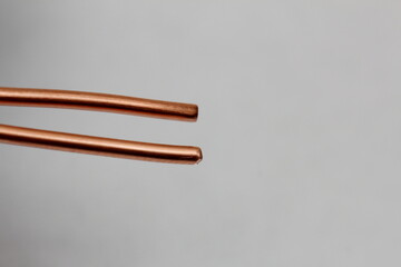 pieces of copper wire are scattered across the white background