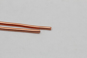 pieces of copper wire are scattered across the white background