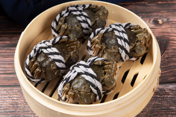 Raw Chinese mitten crab, shanghai hairy crab isolated on wooden background.