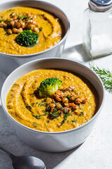 Lentil cream soup with broccoli and dill in gray bowl. Healthy vegan food concept.