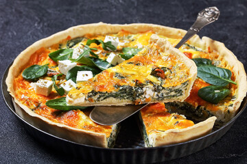 feta spinach parmesan quiche in a baking dish