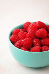 A bowl with ripe bright raspberries