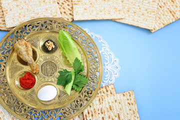 Pesah celebration concept (jewish Passover holiday). Traditional pesah text in hebrew: Passover, horseradish, celery, egg, bone, maror, sweet dates jam