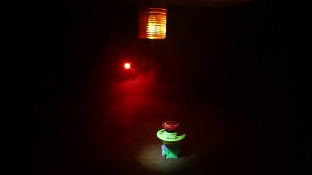Emergency stop button, Disaster protection. Industrial concept. Red button on table in dark low key background. Selective focus